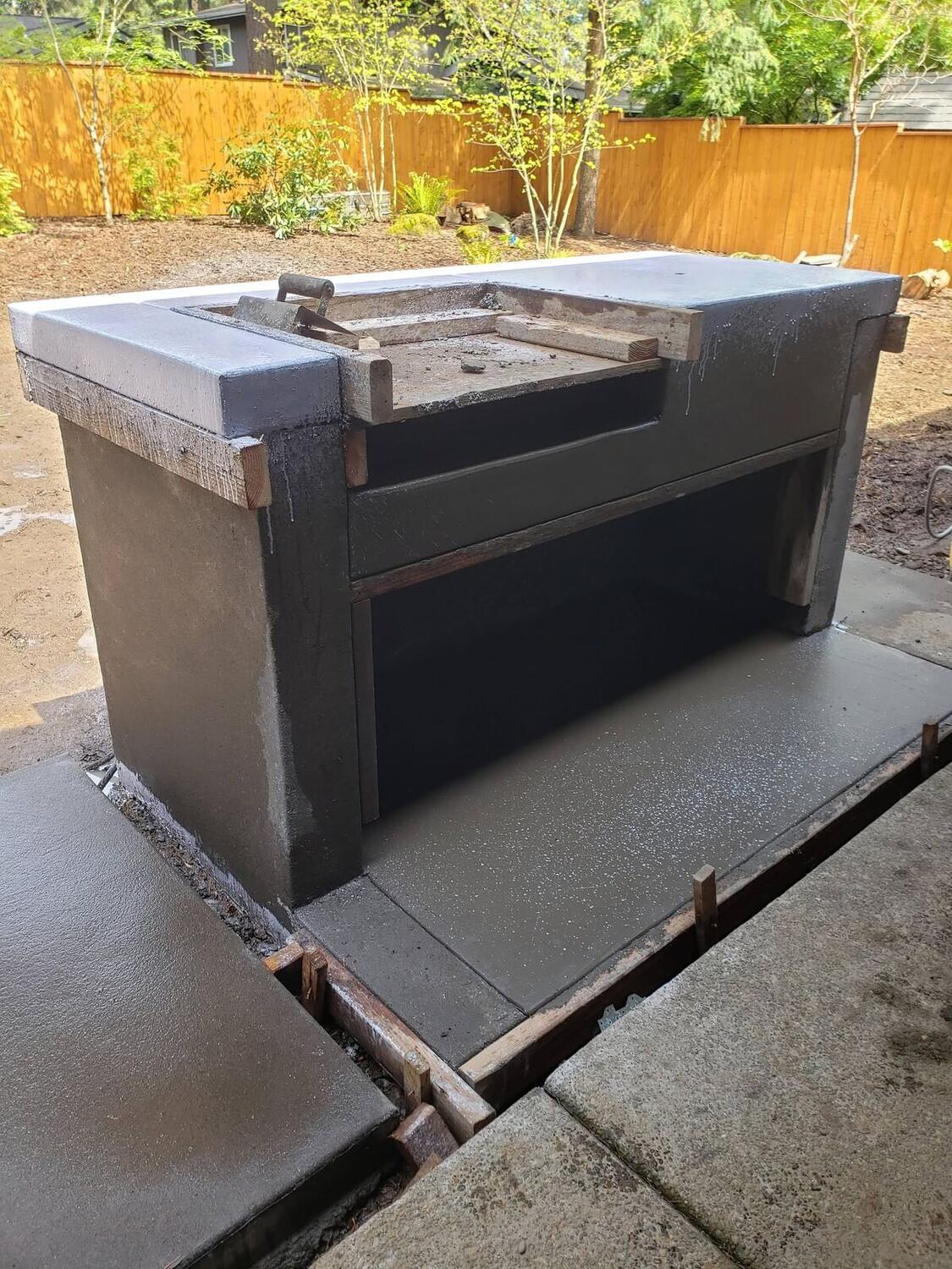 Concrete patio with built-in grill area by Zuber Concrete