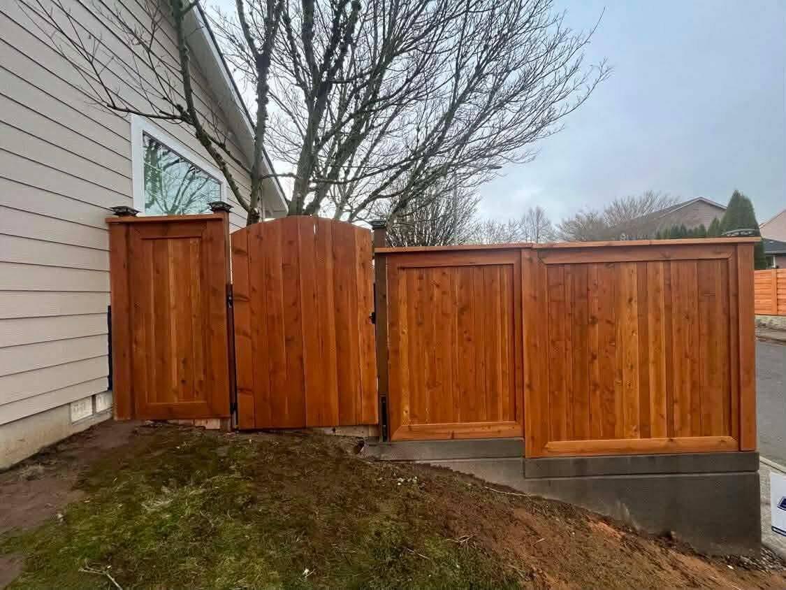 Retaining wall with fencing and lighting by Zuber Concrete